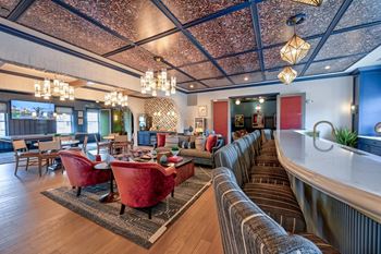 A living room with a red sofa and a wooden floor.